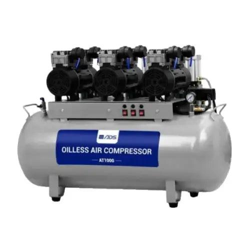 ADS AT1000 oil-free dental air compressor used in dentistry, compact device with hoses and control panel visible.
